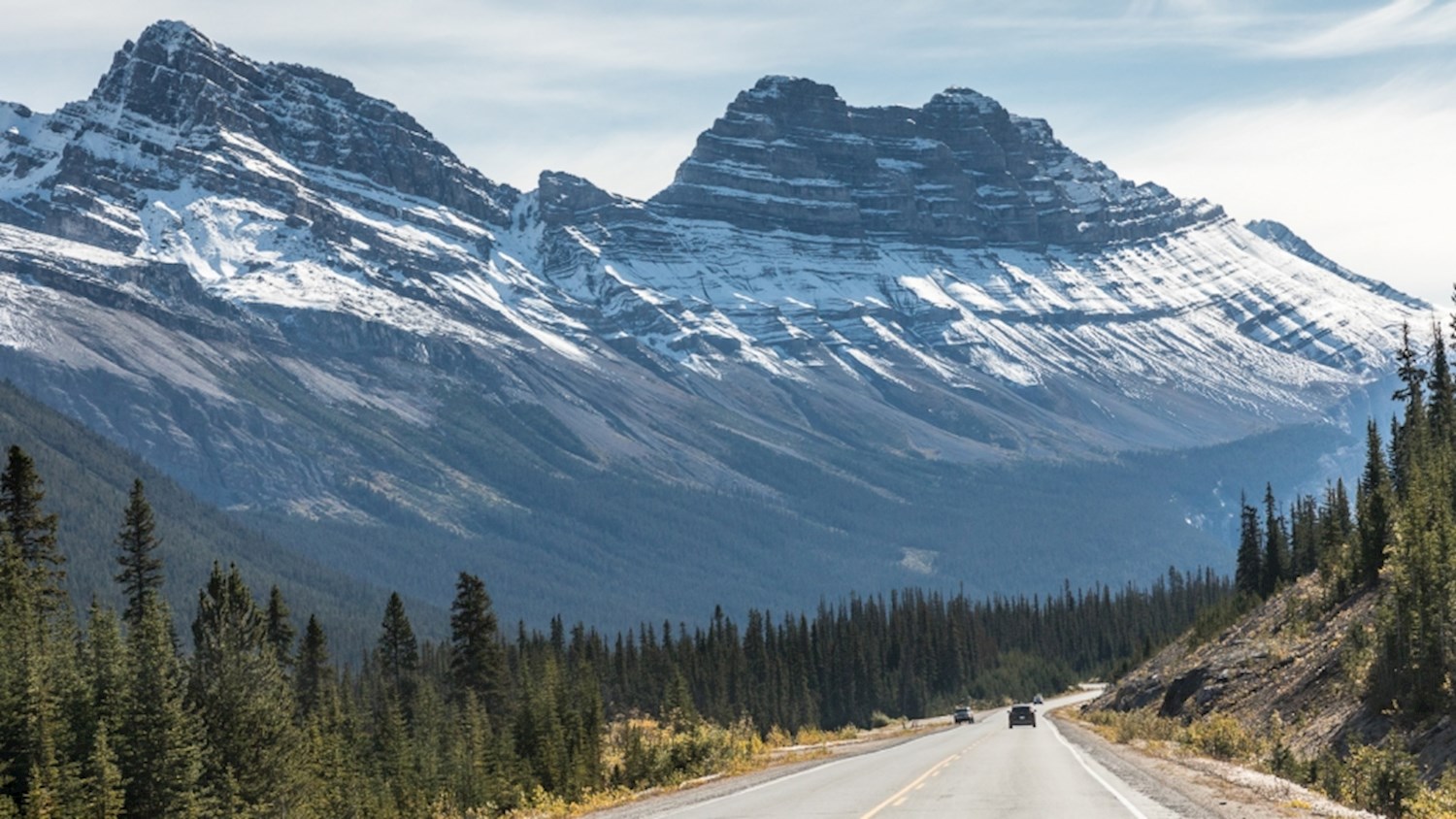 Motor past glaciers and waterfalls on the Icefields Parkway